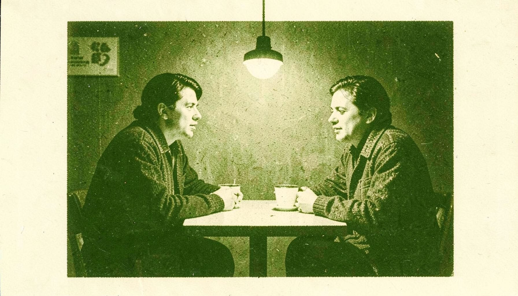 A risograph print in olive green and pale cream showing two people seated across a small café table, their faces half-lit by a single hanging bulb, tension in the air.